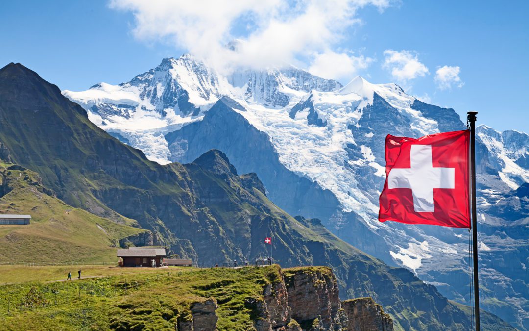 switzer flag over swiss alps