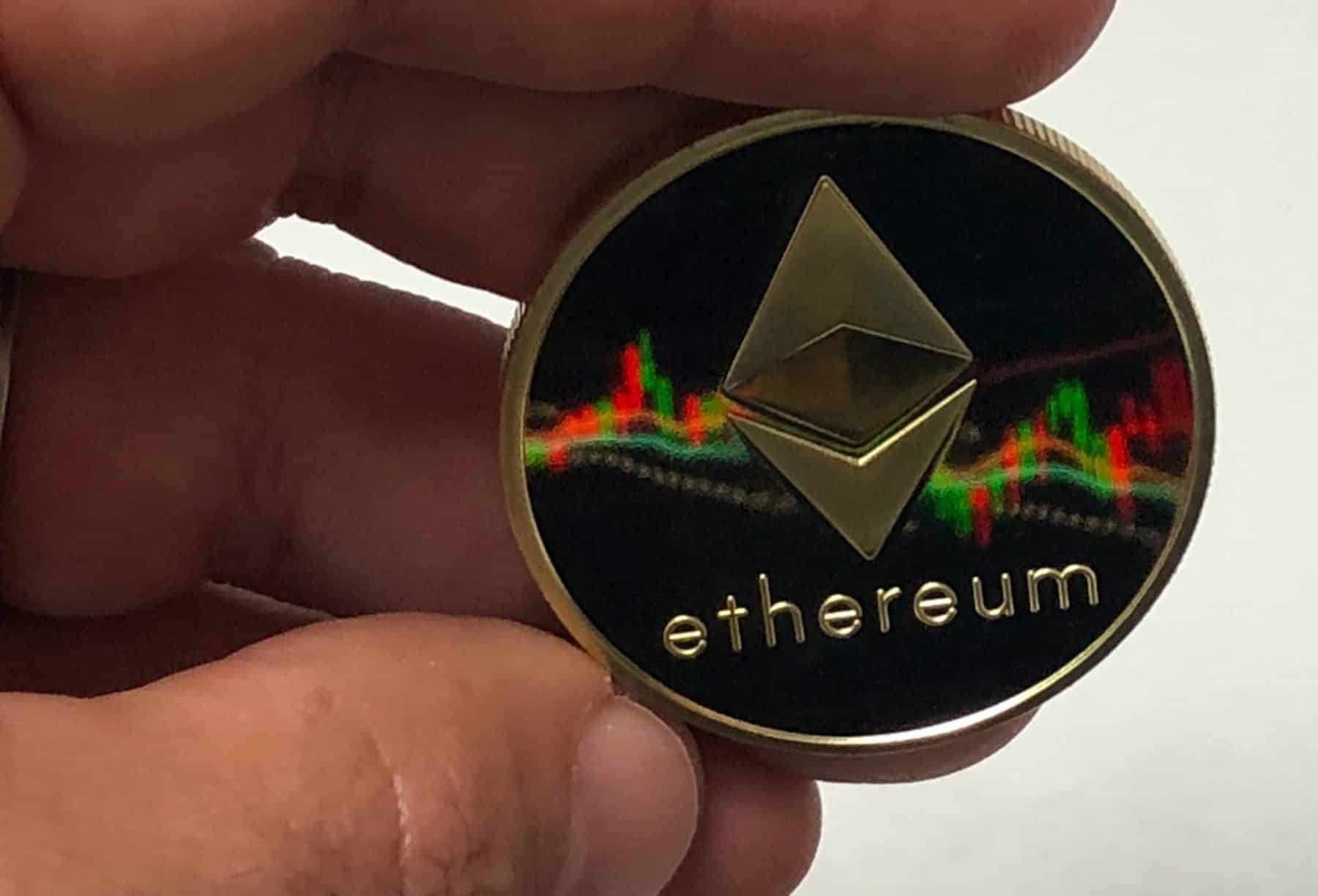 man holding ethereum cryptocurrenci in hand