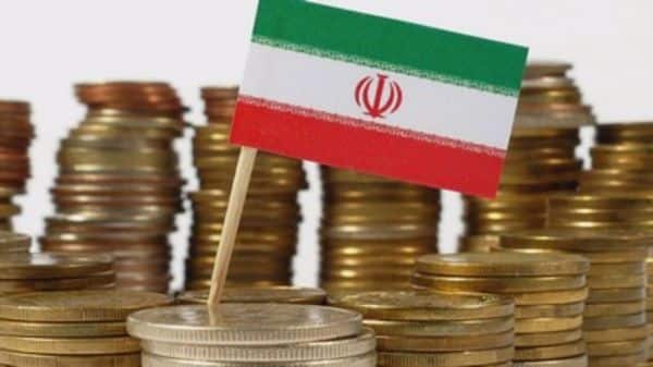 iran flag behind coins