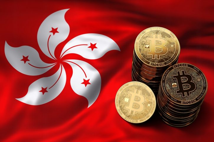 phisycal bitcoins stacked above hong kong flag