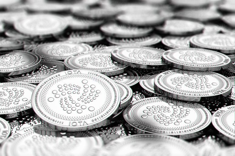 Stack of silver IOTA coins in blurry closeup with copy space above in blurred area. 3D rendering