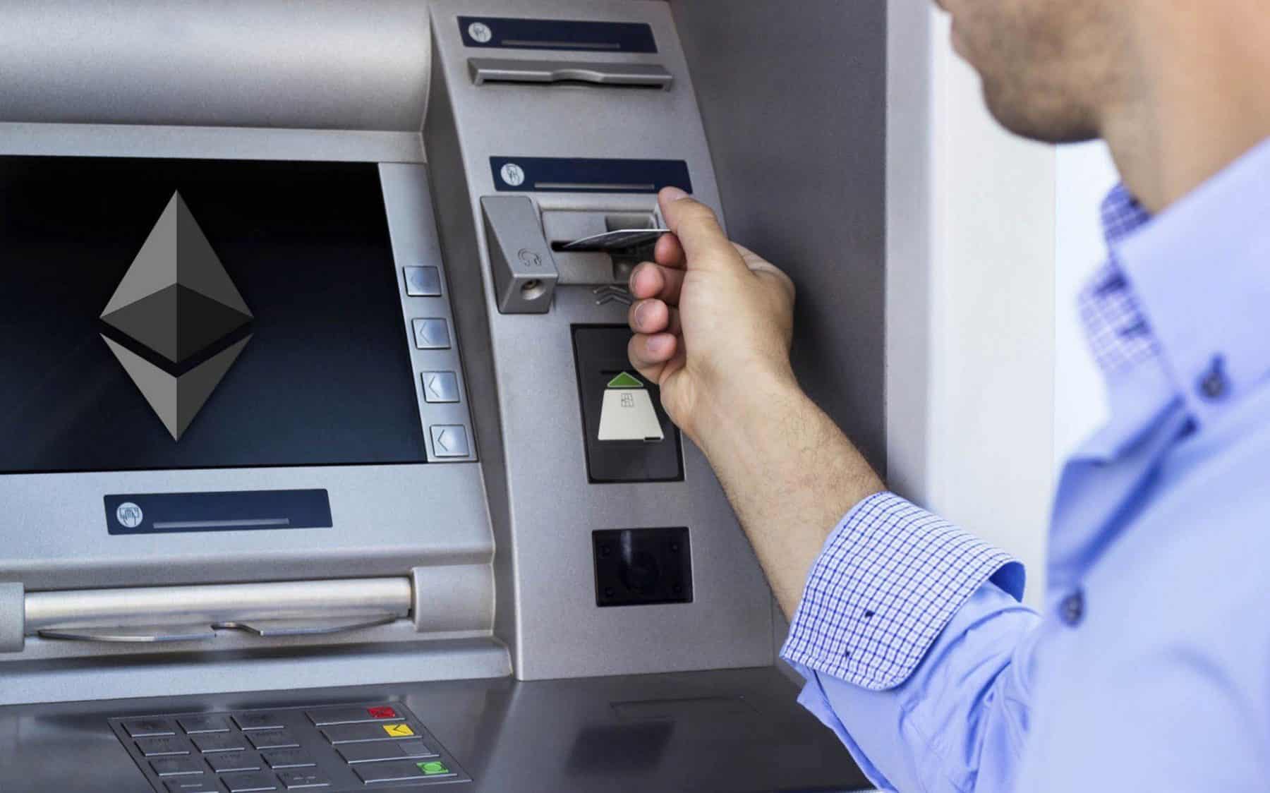 man withdrawing from ethereum atm