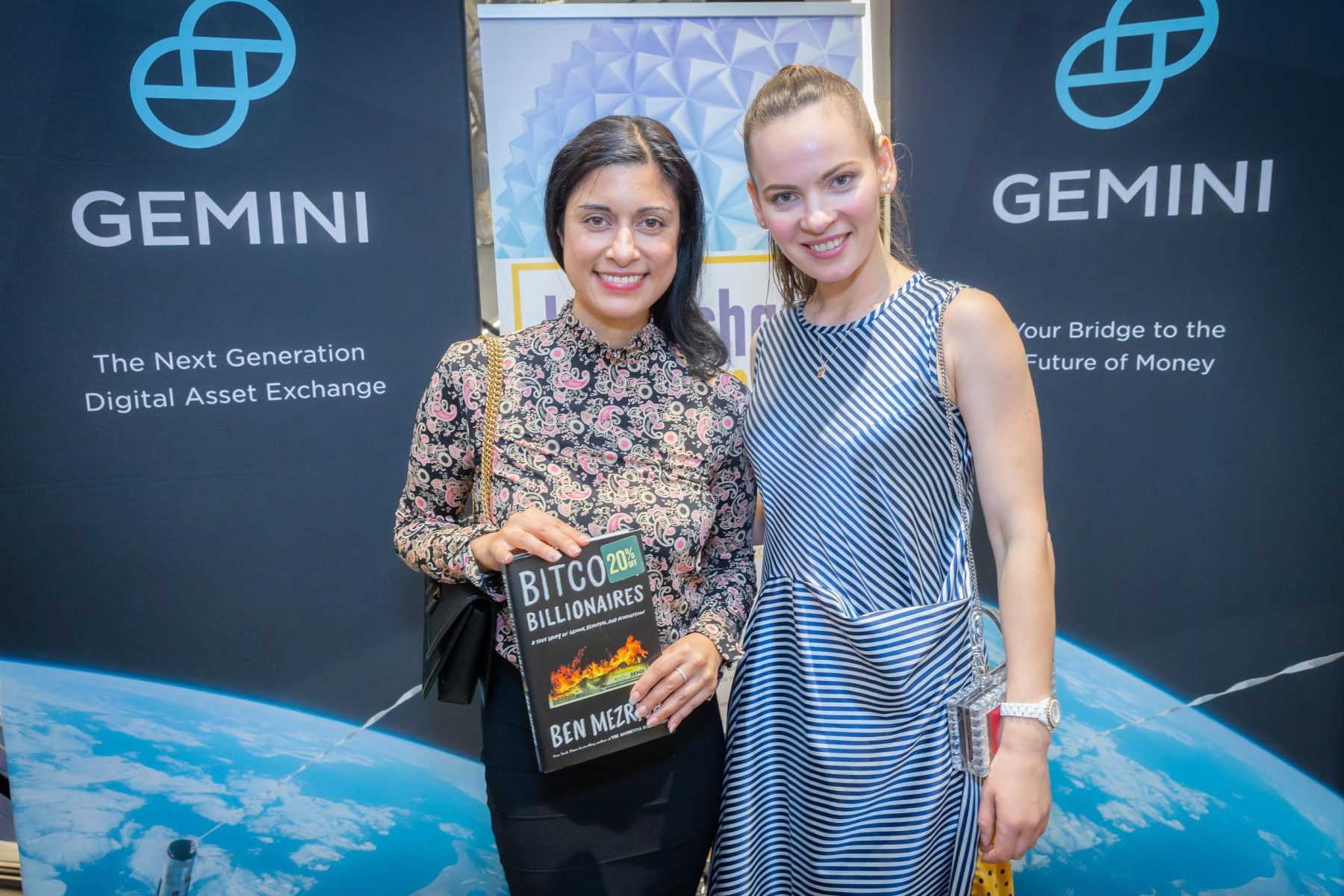blockchainweekend two women in from of gemini banners