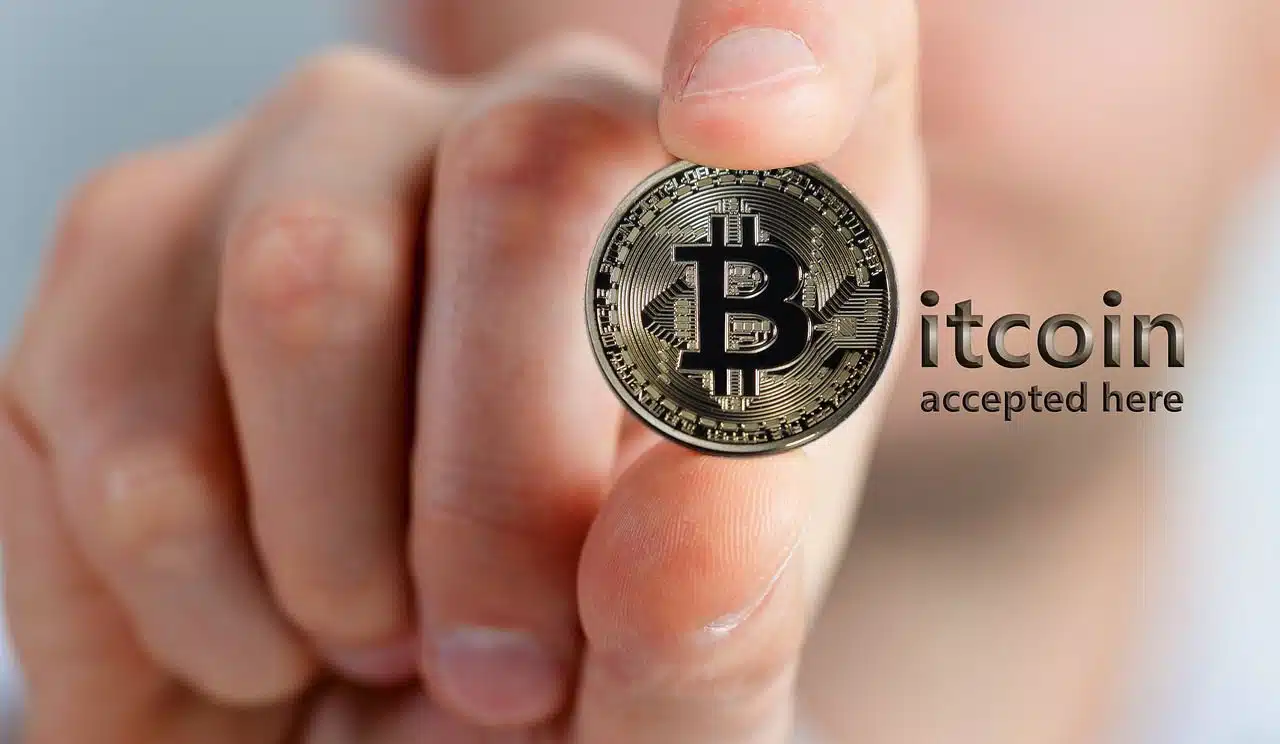 Hand holding a Bitcoin