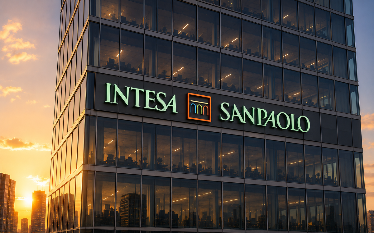 Intesa Sanpaolo logo displayed on a modern glass office tower at sunset.