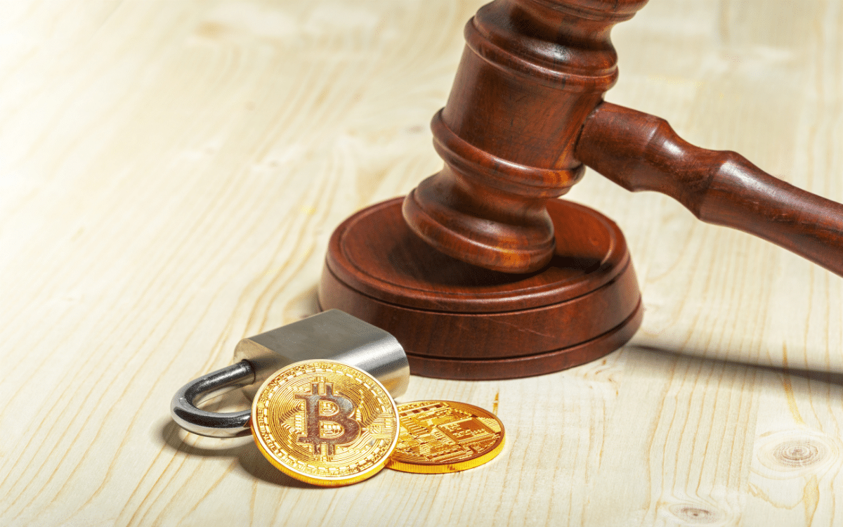 Bitcoin coins beside a padlock and judge’s gavel.