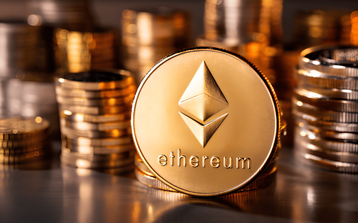 Gold Ethereum coin shown against a background of stacked coins.